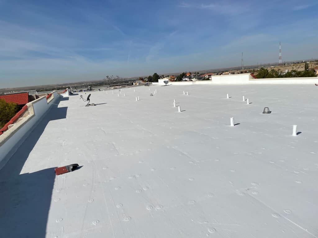 A white, flat commercial roof in El Paso.