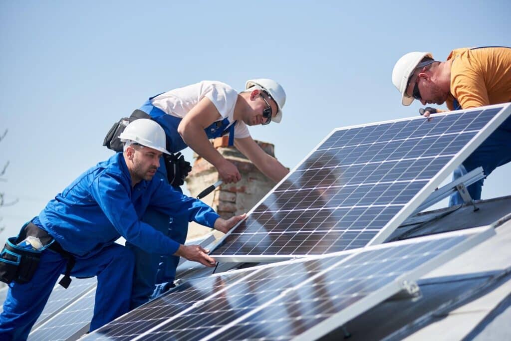 3 men installing solar panels