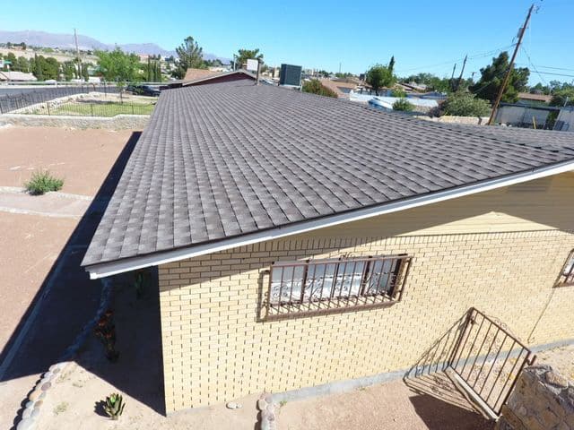 A new roof on a yellow brick house in El Paso.