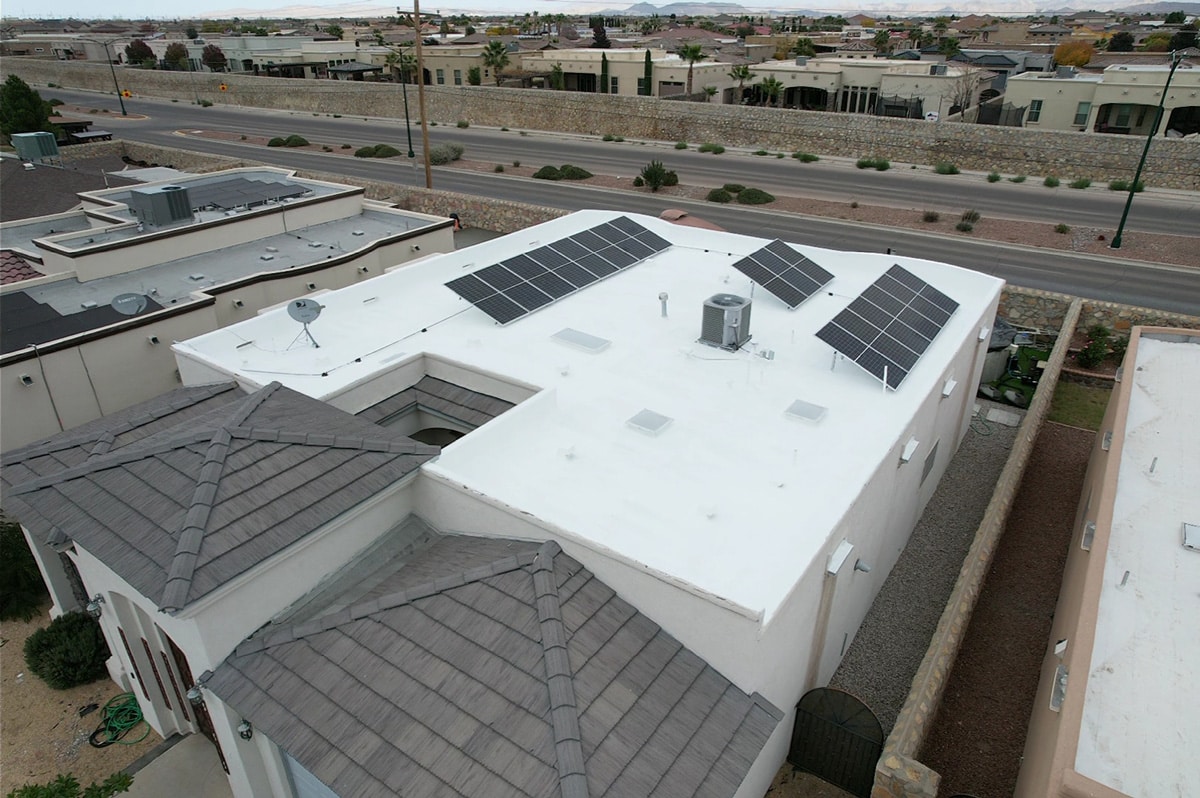 A white roof with solar panels and roof coating in El Paso.