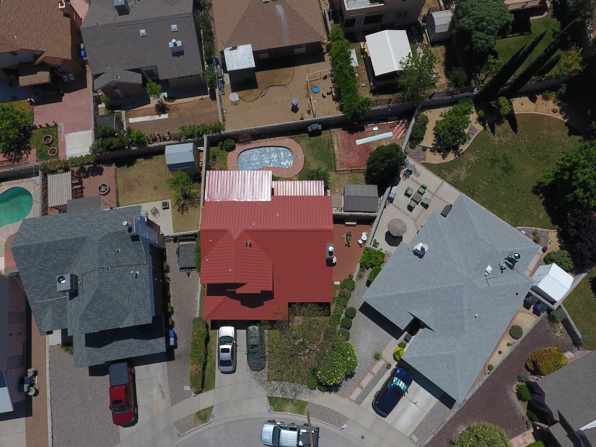 An aerial view of three El Paso houses’ roofs.