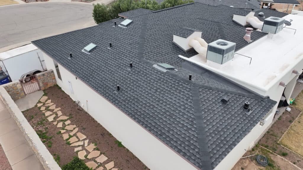 An aerial view of a new roof on a white El Paso house.