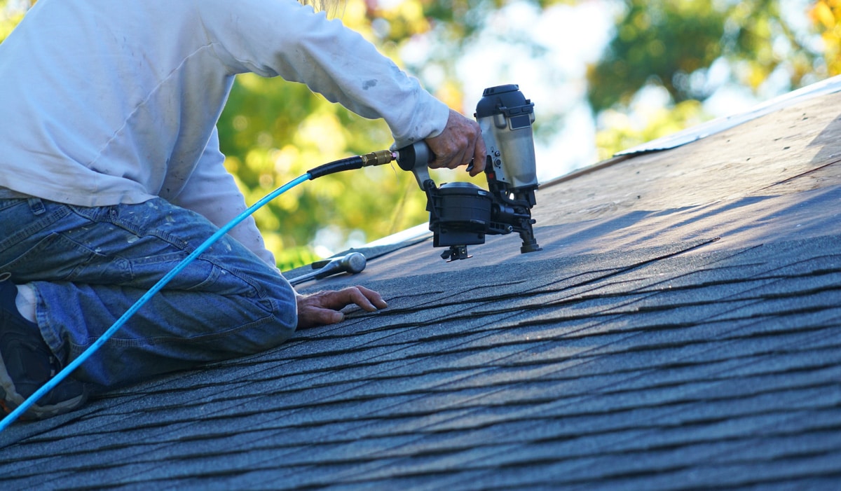 A roofing contractor performing a roof repair in El Paso.